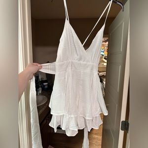 Spaghetti strap, crossed in the back frilly romper with tie. Never worn!